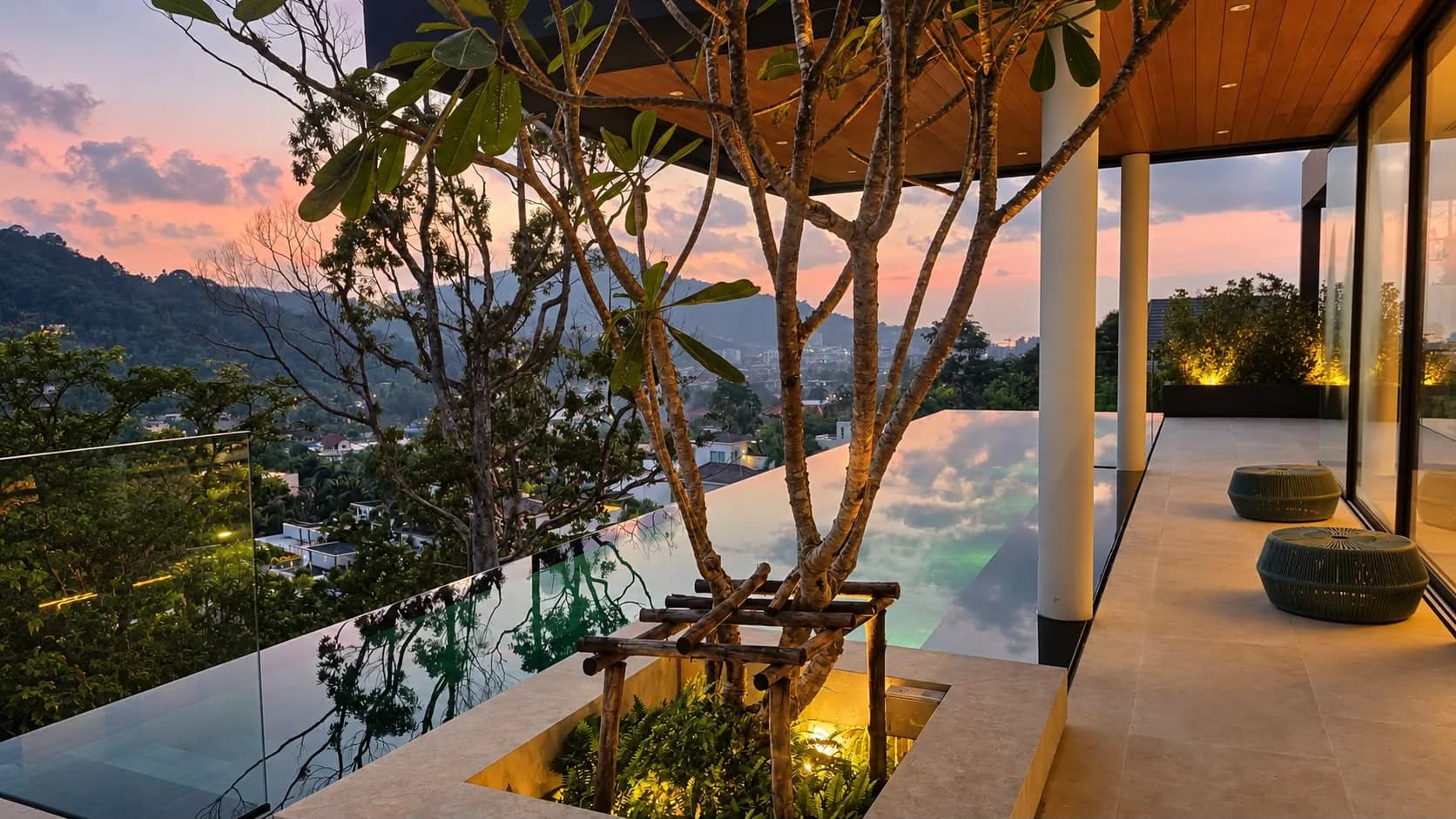 Perch House, pool terrace and frangipani planter at dusk under a pink sky
