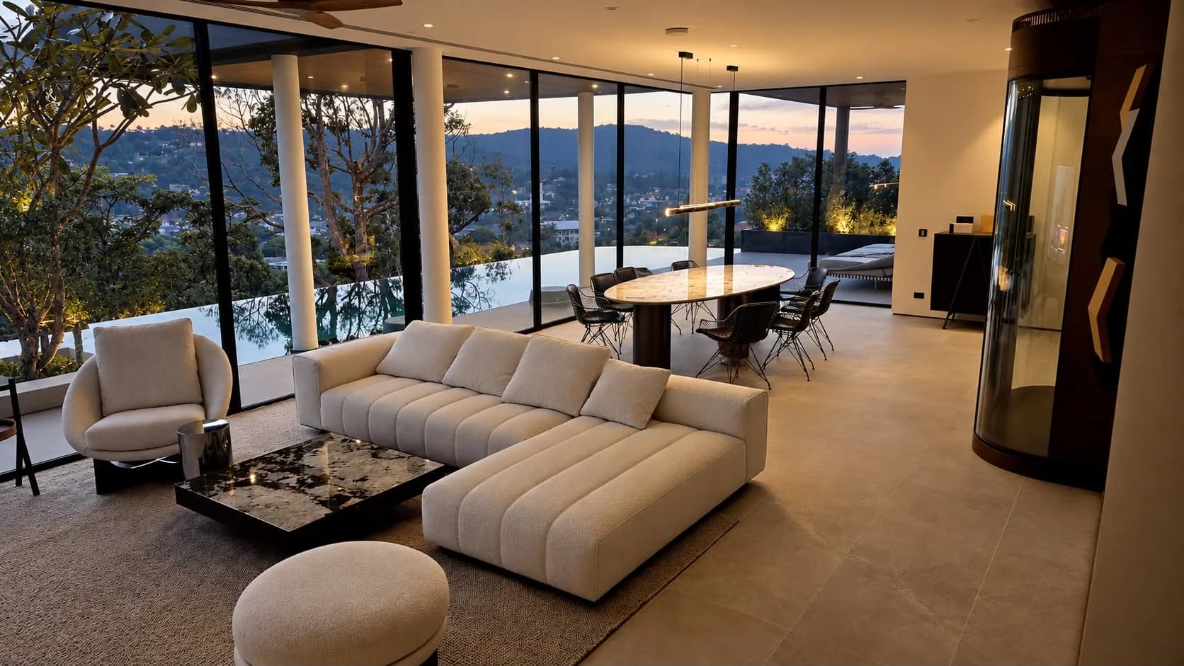 Perch House, living and dining room in the evening with the valley lights beyond